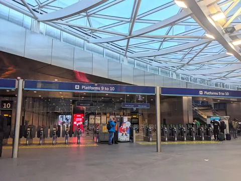Modern ticket gates for Platforms 9 and 10 under the glass roof of London Kings Stock Photos