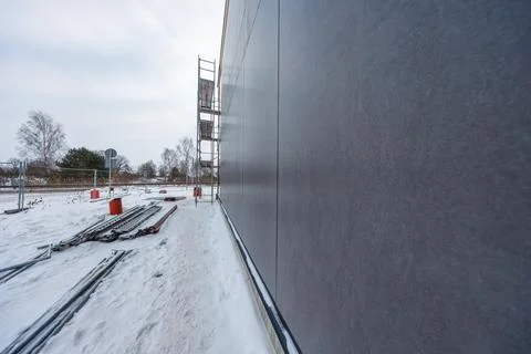 Modern timber frame house facade work with dark cladding in winter Stock Photos