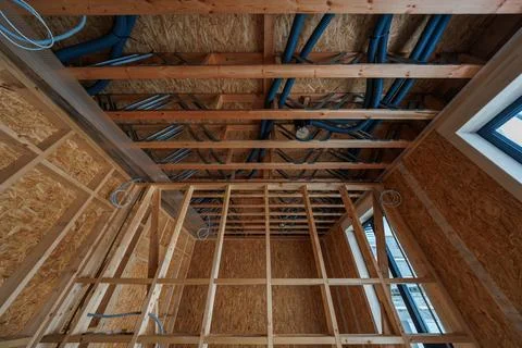 Modern timber frame house interior during rough in with ducts and OSB Stock Photos