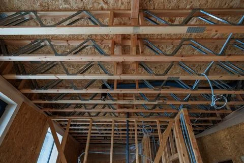 Modern timber frame interior with I joists and metal web trusses Stock Photos
