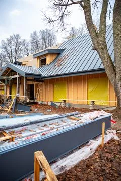 Modern timber house under construction with standing seam roof Stock Photos
