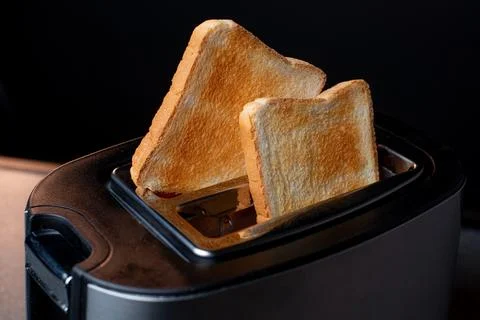 Modern toaster with crispy bread slices, closeup Stock Photos