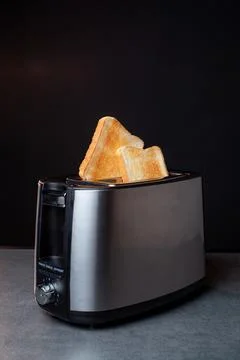 Modern toaster with crispy bread slices, closeup Stock Photos