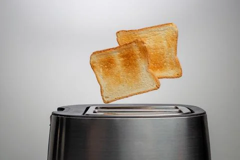 Modern toaster with crispy bread slices, closeup Stock Photos