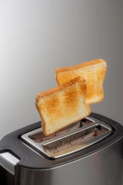 Modern toaster with crispy bread slices, closeup Stock Photos