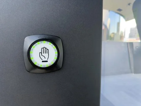 Modern touchless activation button with hand icon and green LED ring, mounted Stock Photos