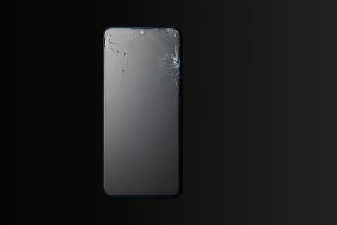Modern touchscreen smartphone with broken screen on dark background. Stock Photos