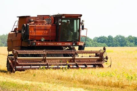 Modern tractor in the field with complex for the plowing. The concept of work in Stock Photos