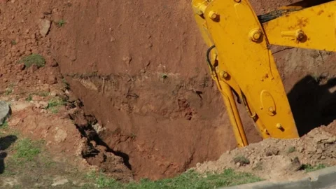 Modern tractor loader with yellow boom and bucket digs sand, close-up, industry Video stock 318907649