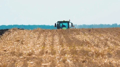 Modern Tractor Plowing Rough Land on Agricultural Field Stock Footage 113876292