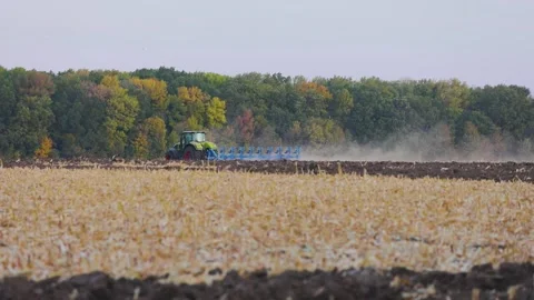 Modern tractor works in the field. Processing the field with a tractor. The Video stock 163900643