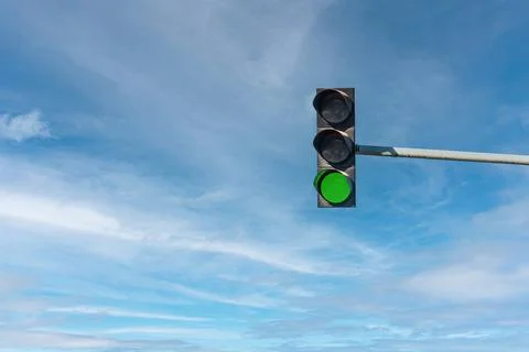 Modern traffic light with green light in front of cloudless sunny blue sky 스톡 사진