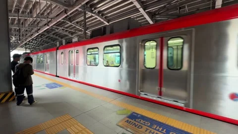 Modern train arriving at an LRT extension station in Parañaque 4K Stock Footage 337979901