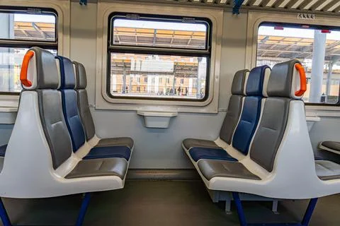 Modern Train Carriage Interior with Comfortable Seating and Large Windows Фото