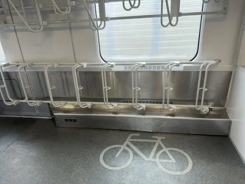 Modern train carriage interior showcases designated bicycle parking racks a.. Stock Photos
