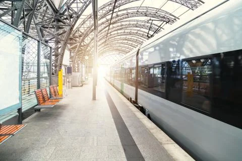 Modern train at empty platform of railway station Stock Photos