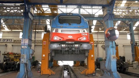 Modern train engine on a garage lift Stock Footage