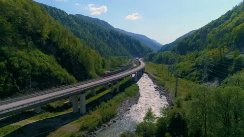 The Modern Train Goes On A Bridge Bend In A Beautiful Mountain Canyon Video stock 89179275