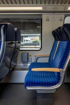 Modern train interior with empty seats and power sockets. Motion blur effec.. Stock-Fotos