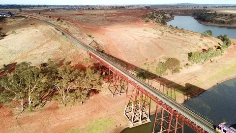 Modern train passing on old railway bridge Stock Footage 99713548