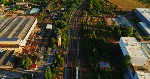 Modern Train Passing Through Aged Railway Factory District In Rural Eastern Stock Footage 300447091