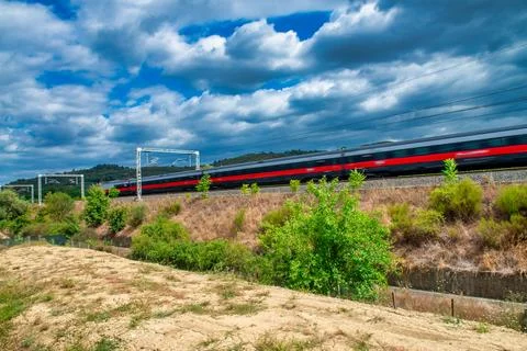 Modern Train Speeds Past Active Construction Zone Stock Photos