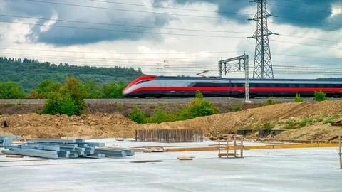 Modern Train Speeds Past Active Construction Zone Stock Photos