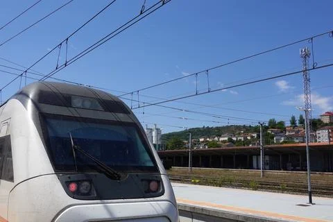 Modern Train at a Station Platform on a Clear Day Stock Photos
