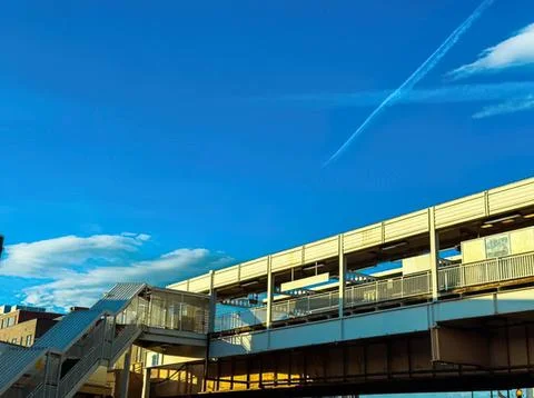 Modern train station with platforms and sky view during daytime Stock Photos