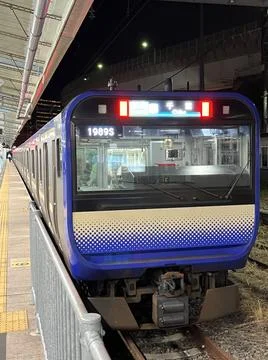 Modern Train Stopped at Station in Evening Stock Photos