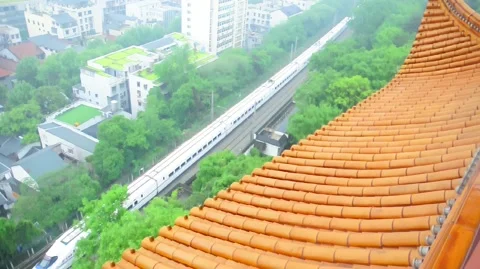 Modern train viewed from a temple. Slow motion Stock Footage 334936530