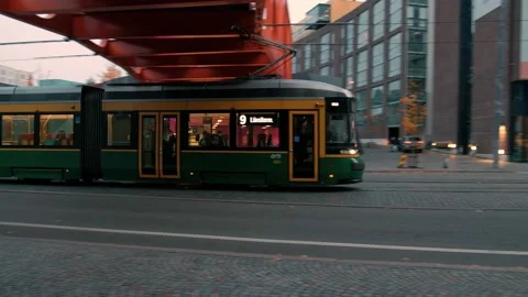 Modern Tram is moving under the bridge in Helsinki, Finland Stock Footage 163149999