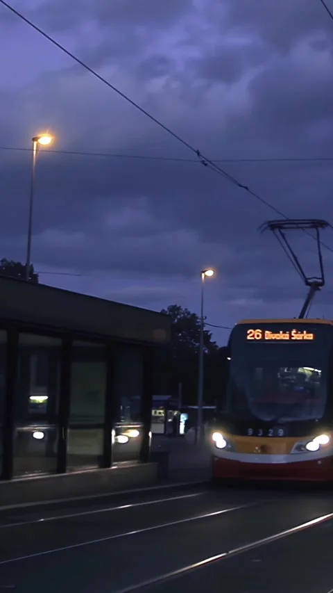Modern Tram Passenger Train Moving At Dusk Near Subway Station - 4K Vertical Stock Footage 338040742