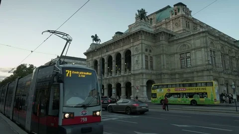 Modern tram pulls away at Vienna Opera House Stock Footage 82008741
