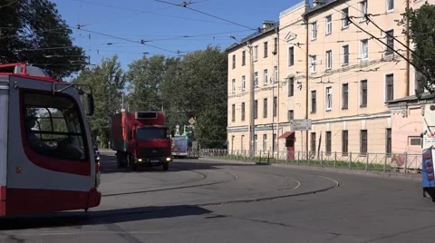 Modern tram in red and silver livery turns left and then right at Arsenalnaya St Stock Footage 67468146