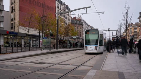 Modern trams passing a stop in the suburbs of Paris Stock Footage 306866769