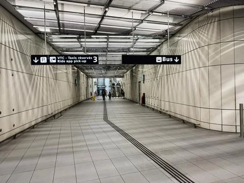 Modern transit corridor with bus and taxi ride app pick up signage at Paris.. Stock Photos