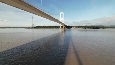 Modern transport structure over river casting shadow on water Stock-Footage 166697579
