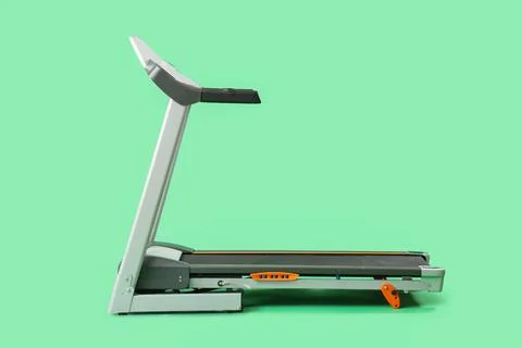 Modern treadmill on green background Stock Photos