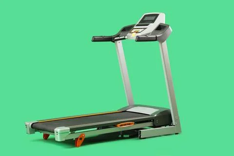 Modern treadmill on green background Stock Photos