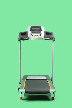 Modern treadmill on green background Stock Photos