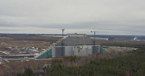 Modern triangle-shaped building in process of construction Stock Footage 231983598