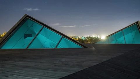 Modern Triangular Glass Architecture at Night Stock Footage 304119710