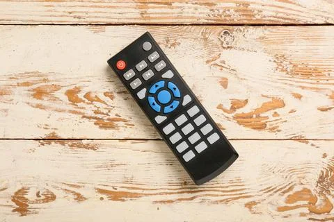 Modern TV remote control on beige wooden background Stock Photos