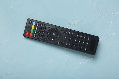 Modern TV remote control on blue grunge background Stock Photos