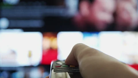 Modern TV Remote Control close-up - hand choosing content to watch Stock Footage 166804081