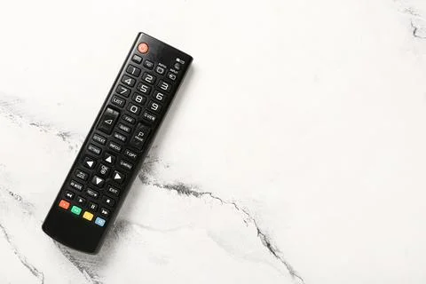 Modern TV remote control on marble background Stock Photos