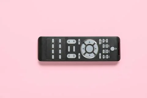 Modern TV remote control on pink background Stock Photos