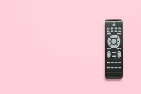 Modern TV remote control on pink background Stock Photos