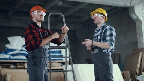 Modern with two builders discuss work for site design. Work safety. Stock Footage 130776414